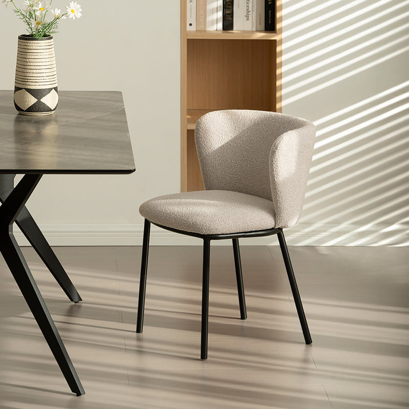 Silla de comedor Karin en tejido bouclé beige, con respaldo alto y patas de metal negro. Perfecta para comedor, cocina o oficina en casa. Colección OFCASA.