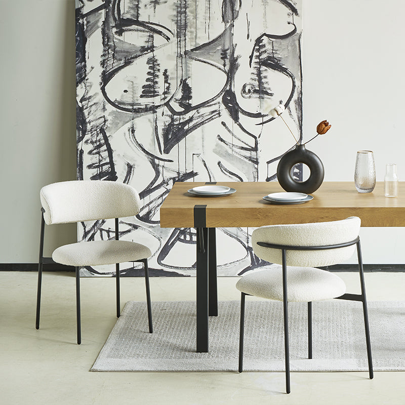 Silla de comedor Zahra en un entorno moderno, junto a mesa de madera y vajilla minimalista